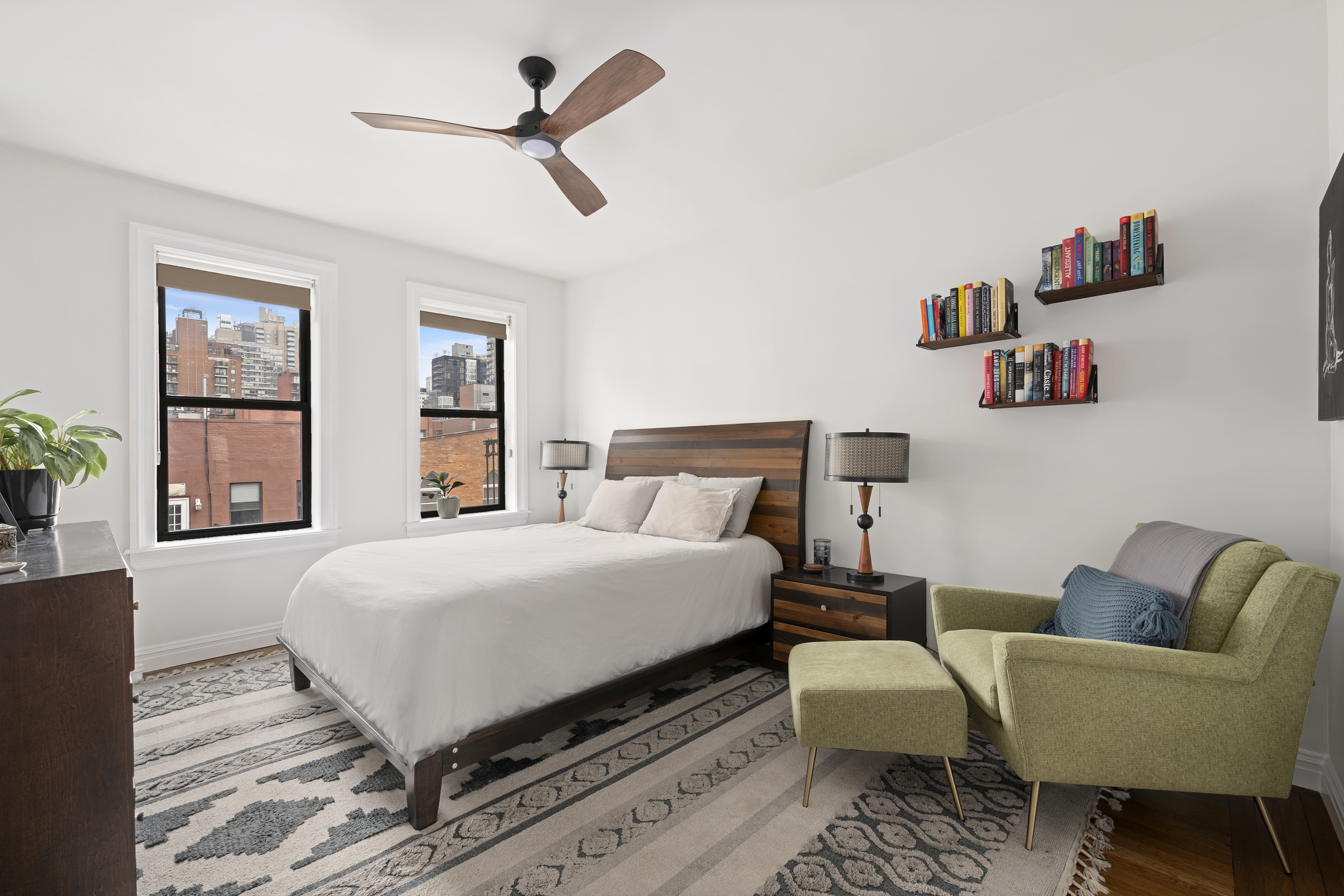 222 East 82nd Street, Unit 5E Manhattan, NY 10028 - Photo 5 of 10 a bedroom with a bed a couch and a potted plant