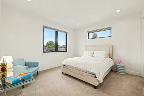 a bedroom with a bed a couch and a window