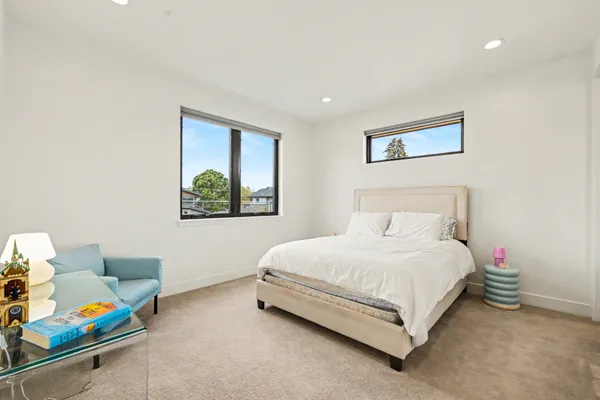 a bedroom with a bed a couch and a window