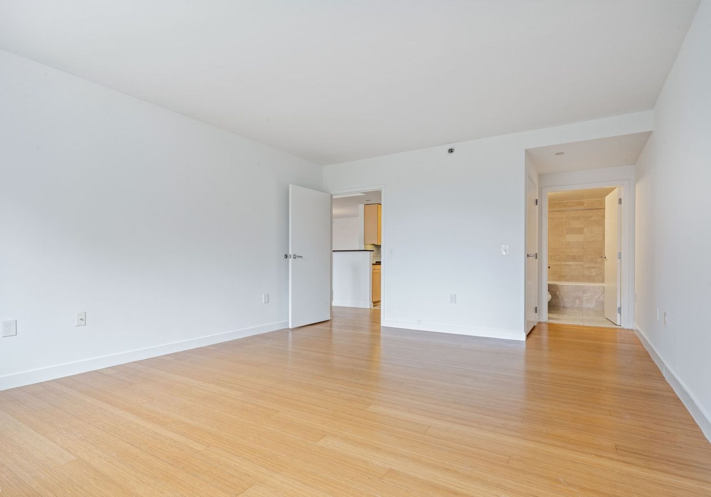 40 West 116th Street, Unit B503 Manhattan, NY 10026 - Photo 8 of 36 a view of an empty room with wooden floor and a window