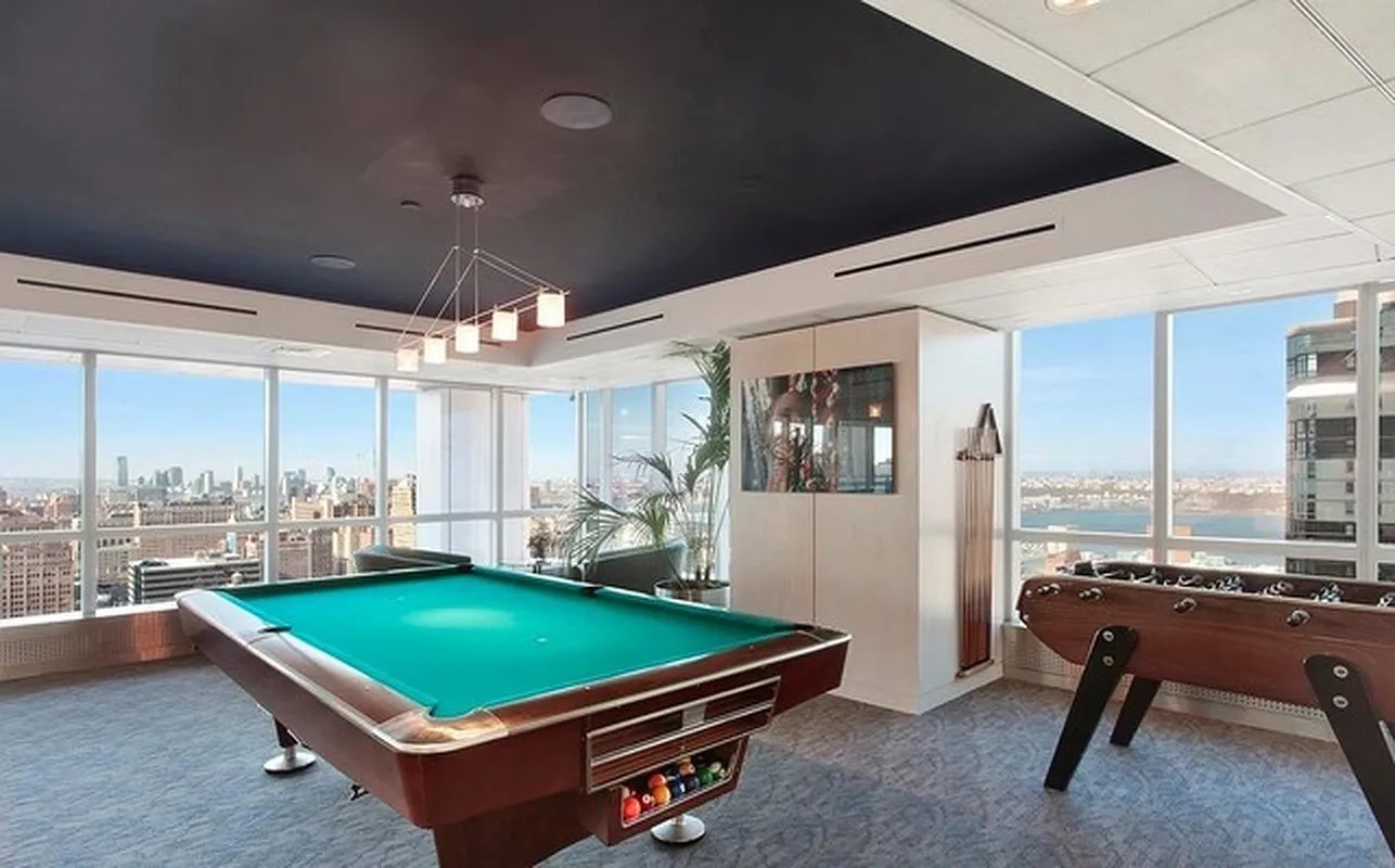 350 West 42nd Street, Unit 12C Manhattan, NY 10036 - Photo 16 of 21 a room with pool table and windows