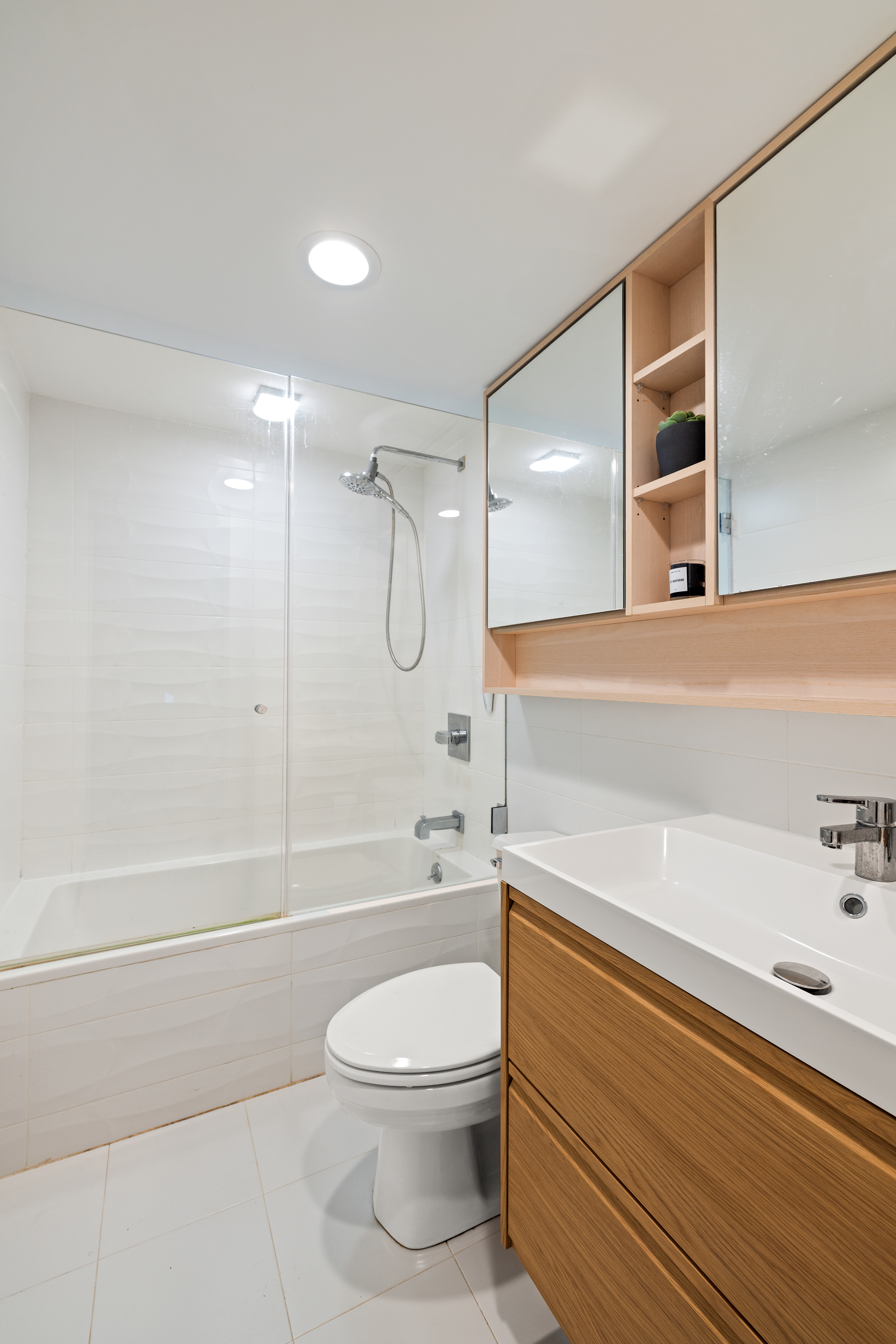 1115-1139 Prospect Avenue, Unit 1B Brooklyn, NY 11218 - Photo 7 of 9 a bathroom with a bathtub shower sink vanity and toilet