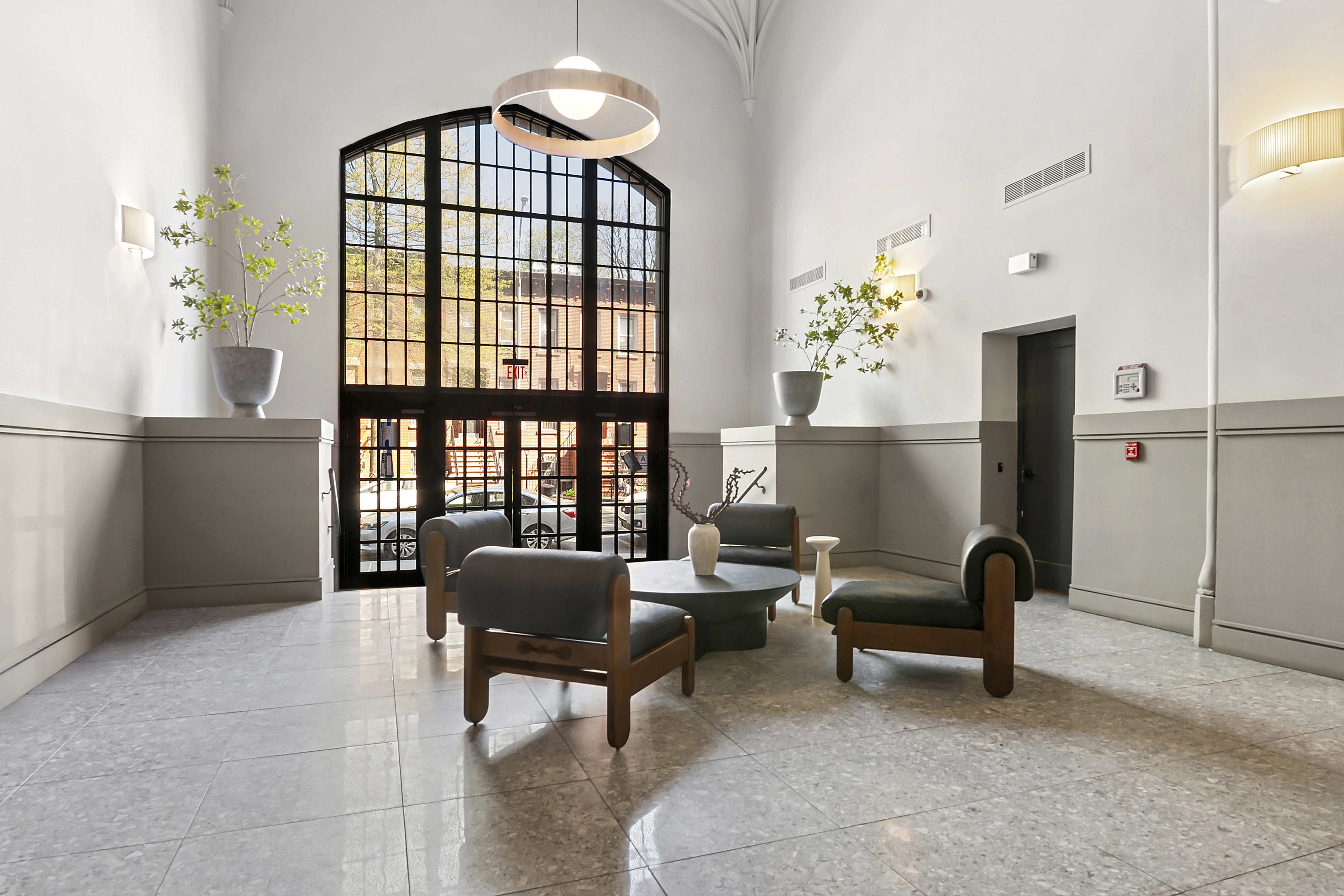 180 Bainbridge Street, Unit 111 Brooklyn, NY 11233 - Photo 19 of 25 a living room with furniture and a window