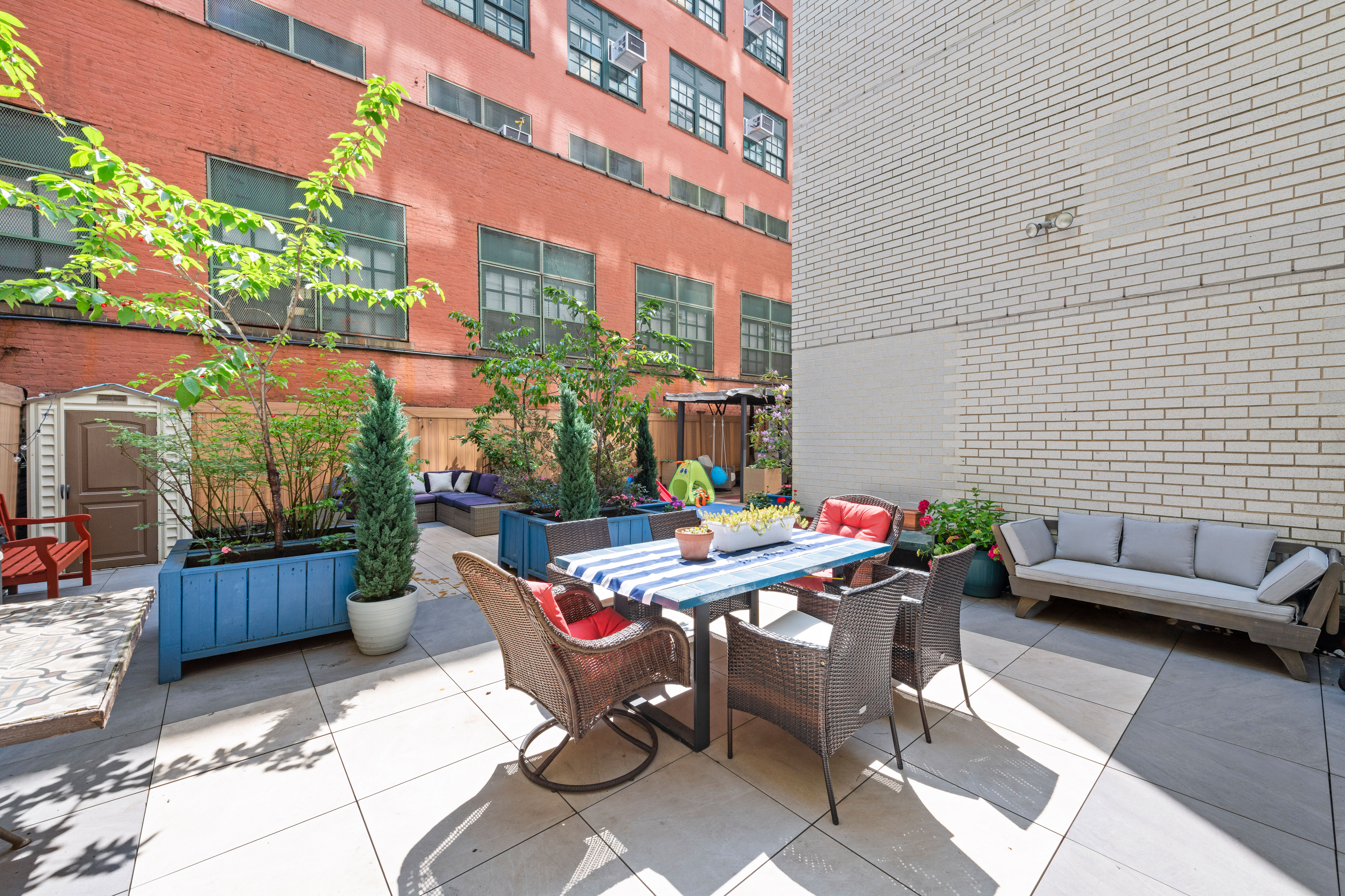 400 East 77th Street, Unit 1CD Manhattan, NY 10075 - Photo 16 of 18 a view of a patio with a dining table and chairs with a potted plants