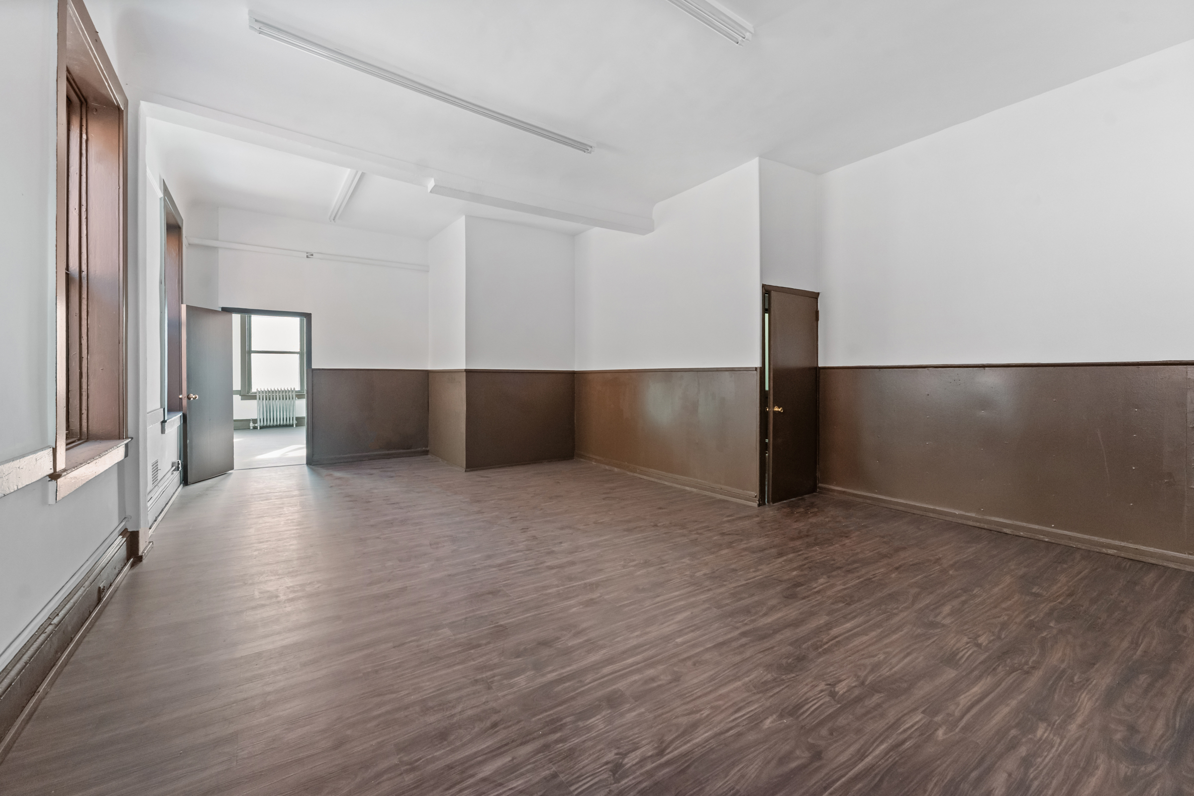 187 Maujer Street Brooklyn, NY 11206 - Photo 7 of 12 a view of an empty room with wooden floor