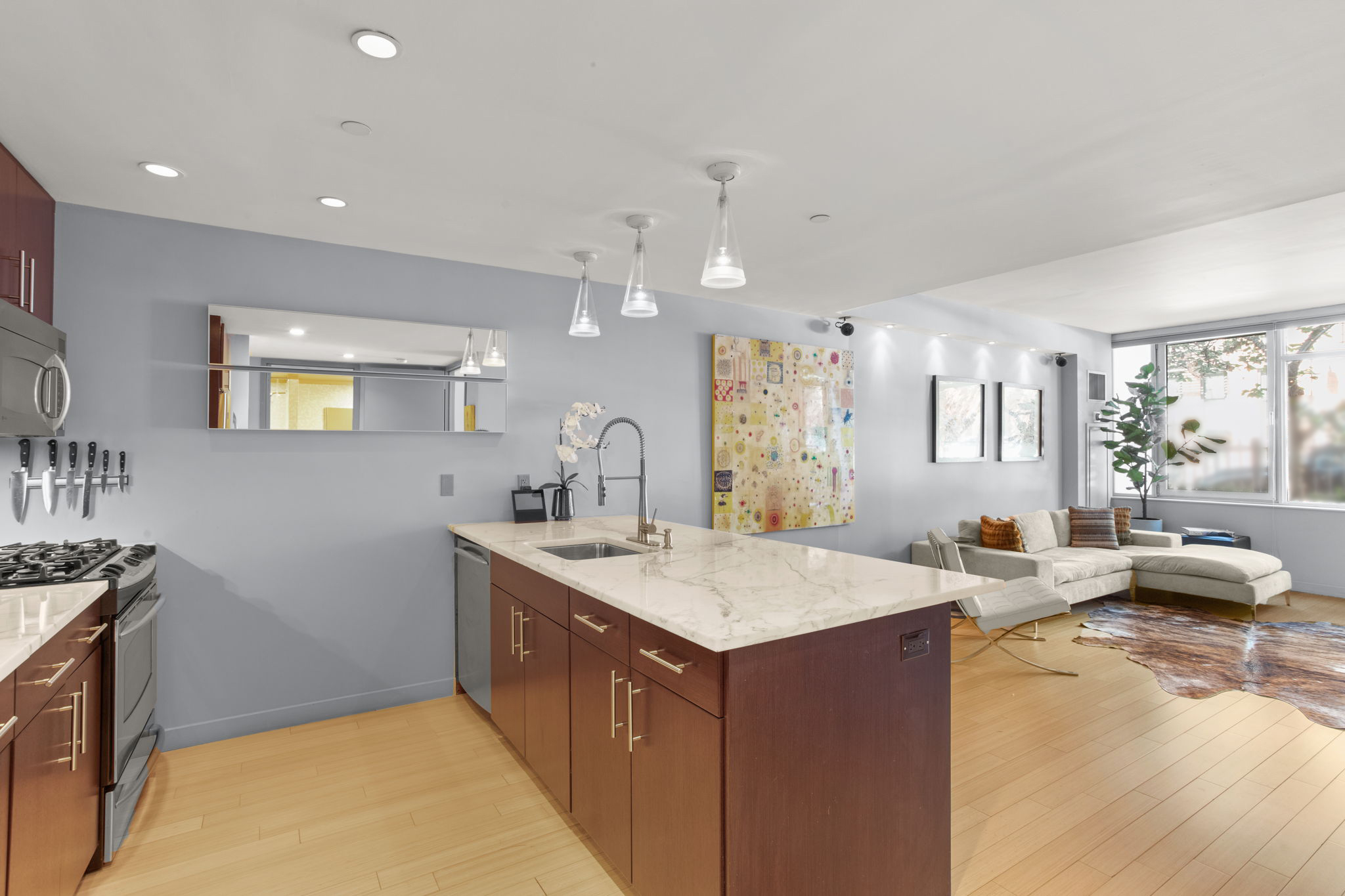 350 West 53rd Street, Unit THG Manhattan, NY 10019 - Photo 6 of 25 a view of a kitchen counter top space with granite countertop a sink and a stove