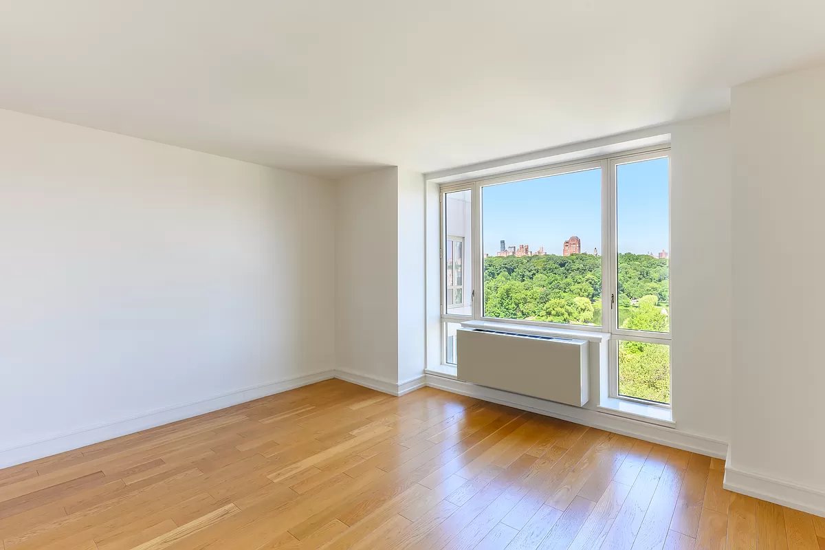 1280 5th Avenue, Unit 10A Manhattan, NY 10029 - Photo 7 of 15 an empty room with wooden floor and windows
