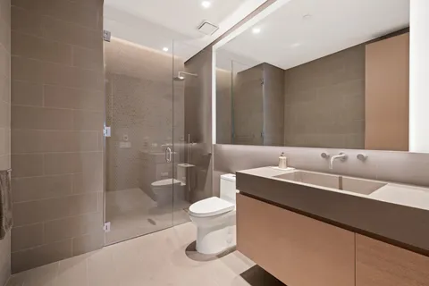 a bathroom with a double vanity sink toilet and a mirror