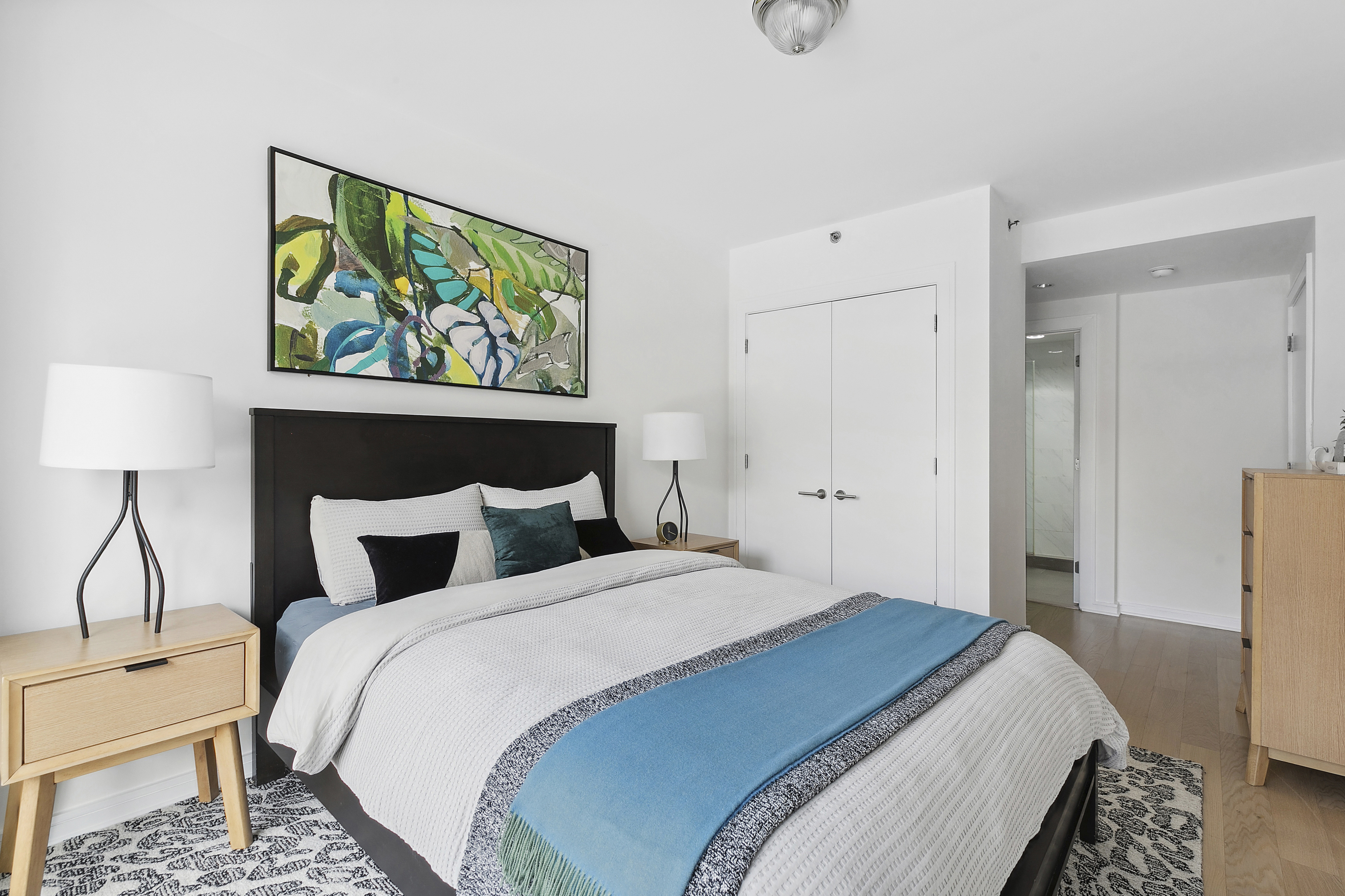 171 West 131st Street, Unit 407 Manhattan, NY 10027 - Photo 7 of 18 a bedroom with a bed and painting on the wall