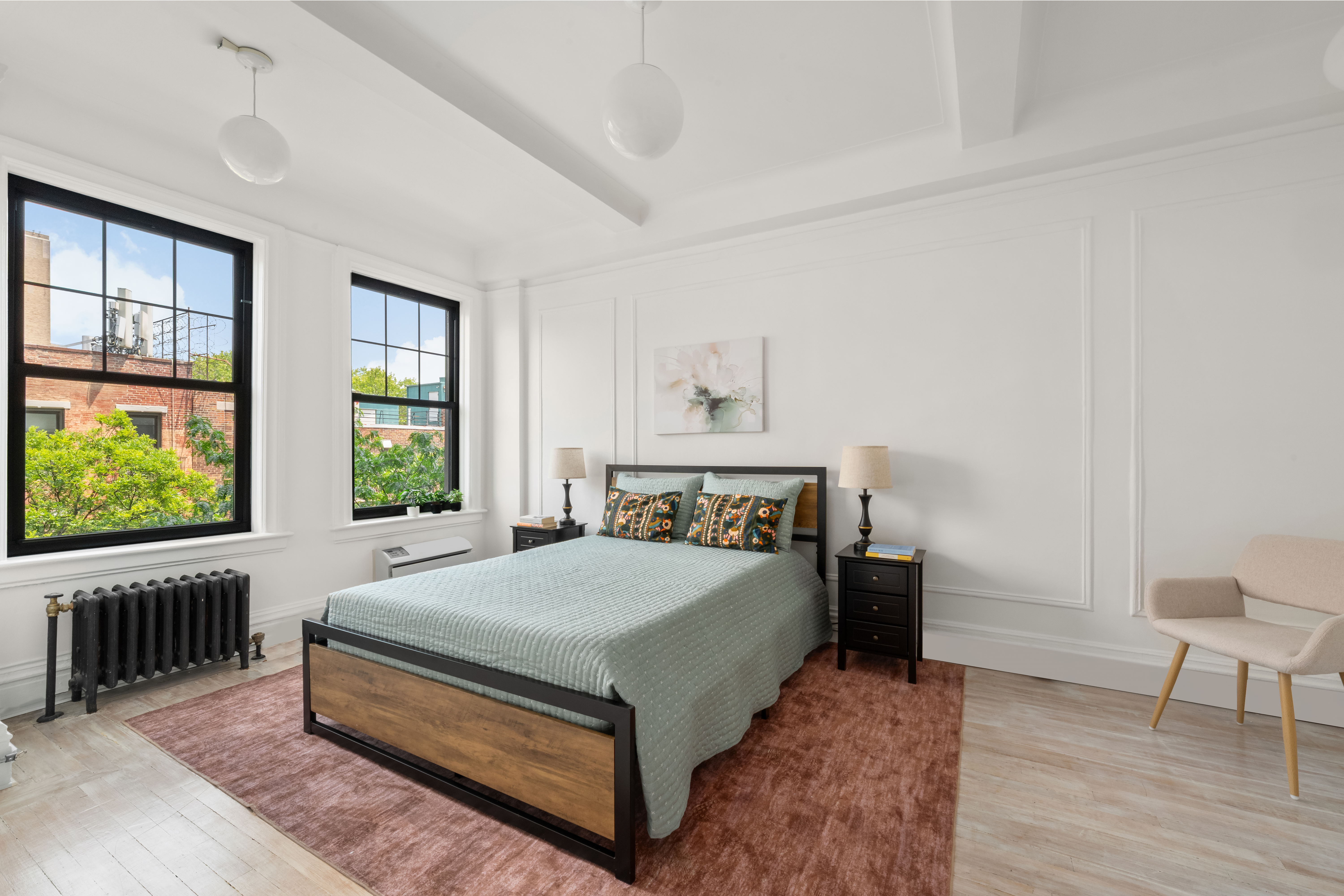 170 2nd Avenue, Unit 5C Manhattan, NY 10003 - Photo 3 of 8 a bed sitting in a spacious bedroom next to a window