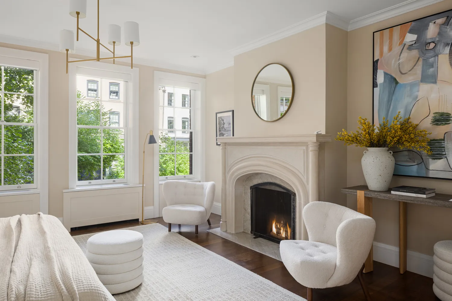 a living room with furniture a large window and a fireplace