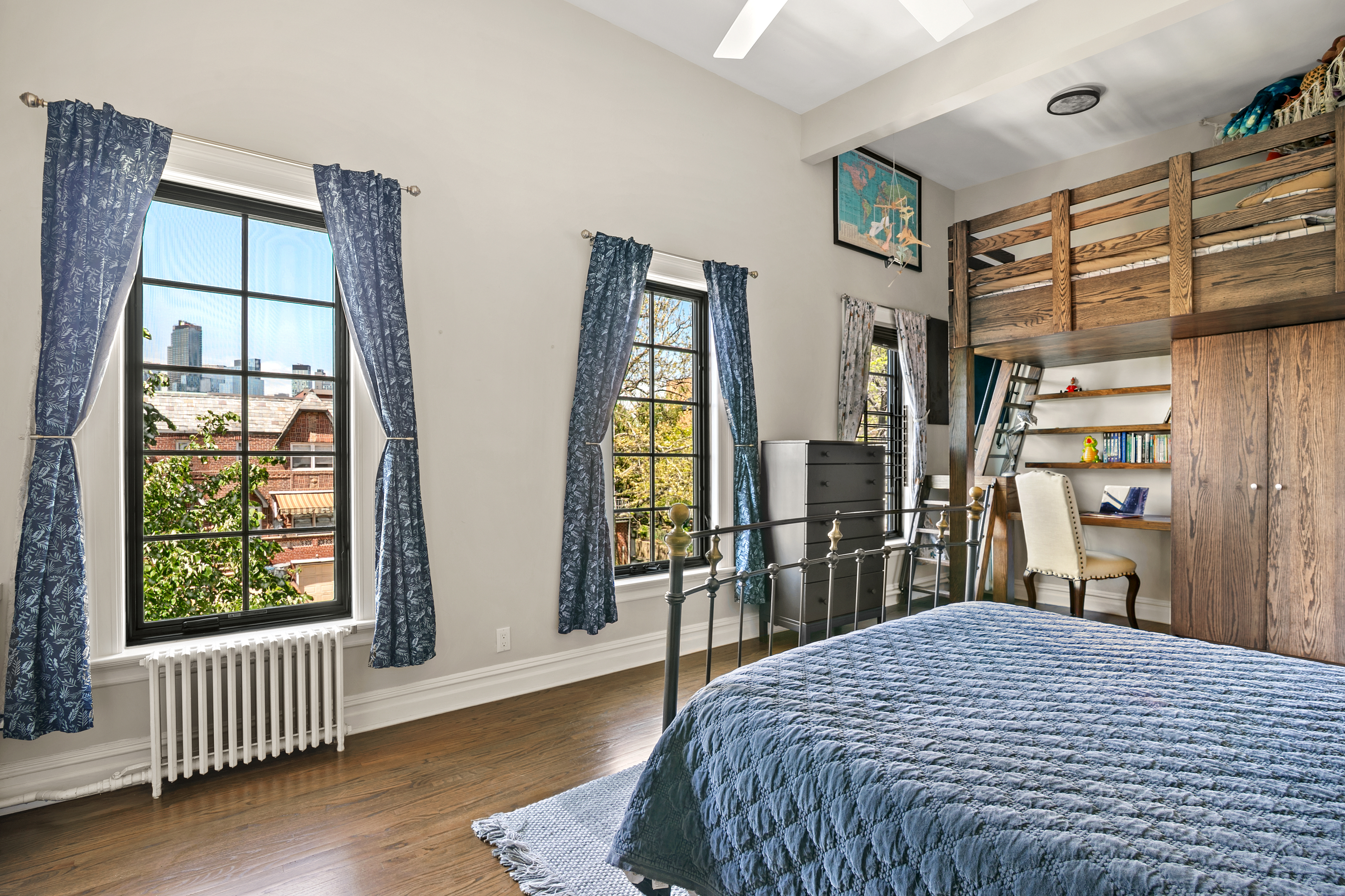 41-27 39th Place Queens, NY 11104 - Photo 4 of 13 a bedroom with a bed and wooden floor