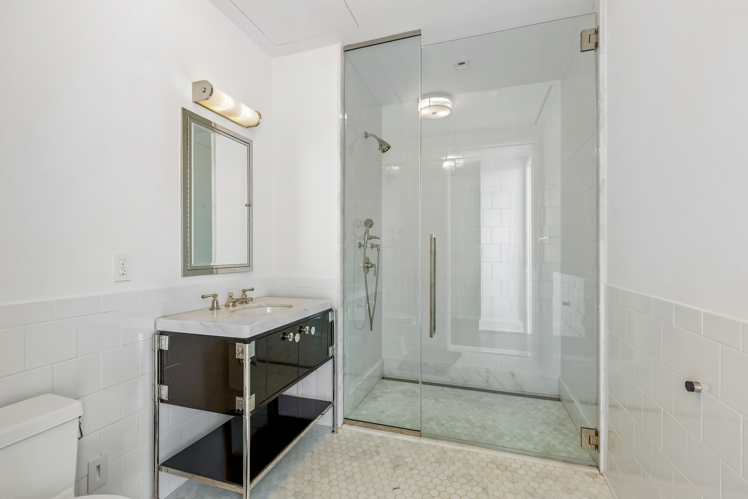 45 East 22nd Street, Unit 42B Manhattan, NY 10010 - Photo 6 of 23 a bathroom with a sink a toilet and shower