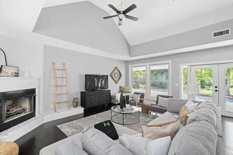 a living room with furniture a fireplace and a flat screen tv