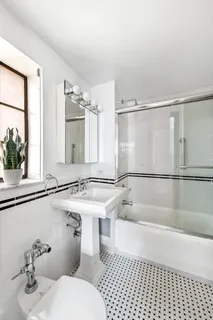 a bathroom with a sink mirror toilet and bathtub