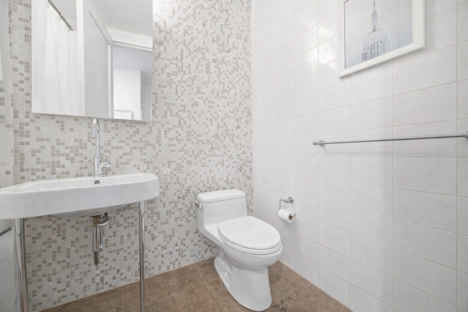 71 Nassau Street, Unit 13C Manhattan, NY 10038 - Photo 12 of 16 a bathroom with a toilet a sink and mirror