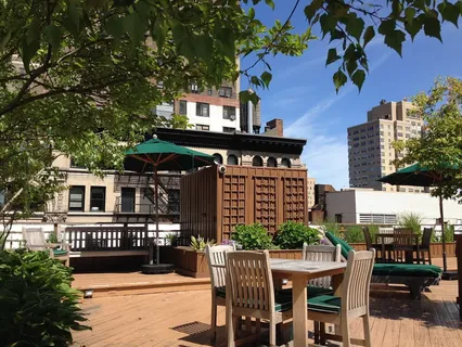 a front view of a house with a tree