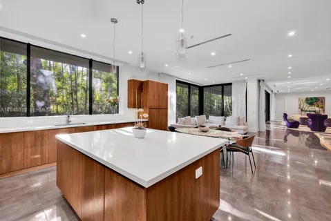 a large kitchen with a large counter top appliances and furniture