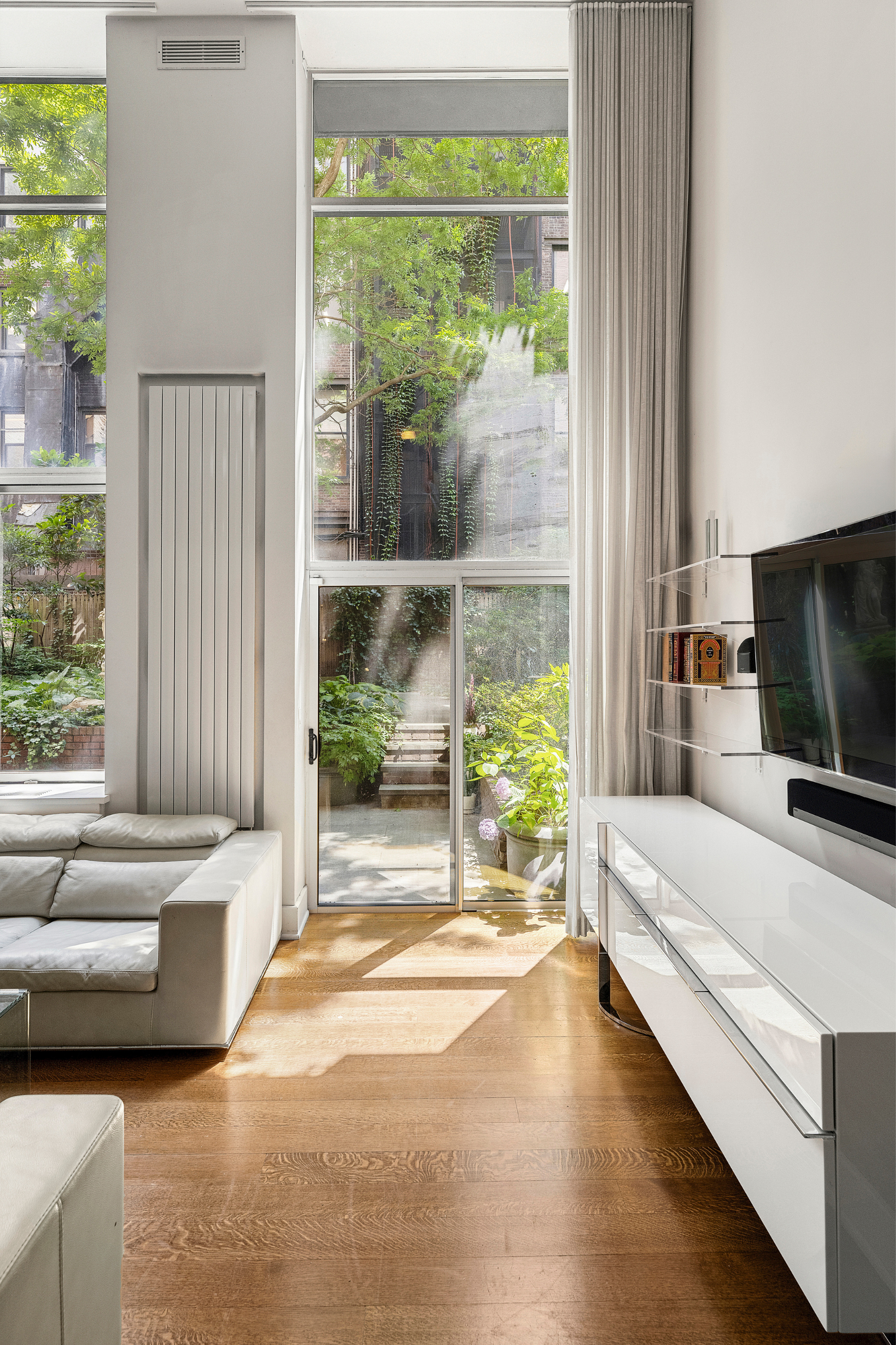 170 East 88th Street, Unit 1C Manhattan, NY 10128 - Photo 6 of 16 a bedroom with furniture and a large window