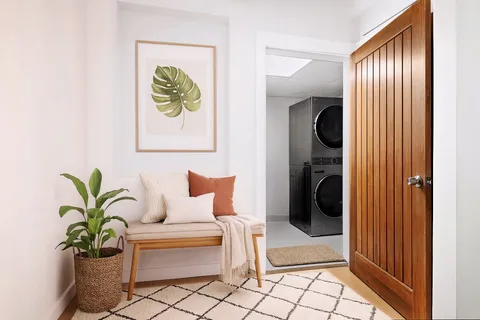 a hallway with a bench and a potted plant
