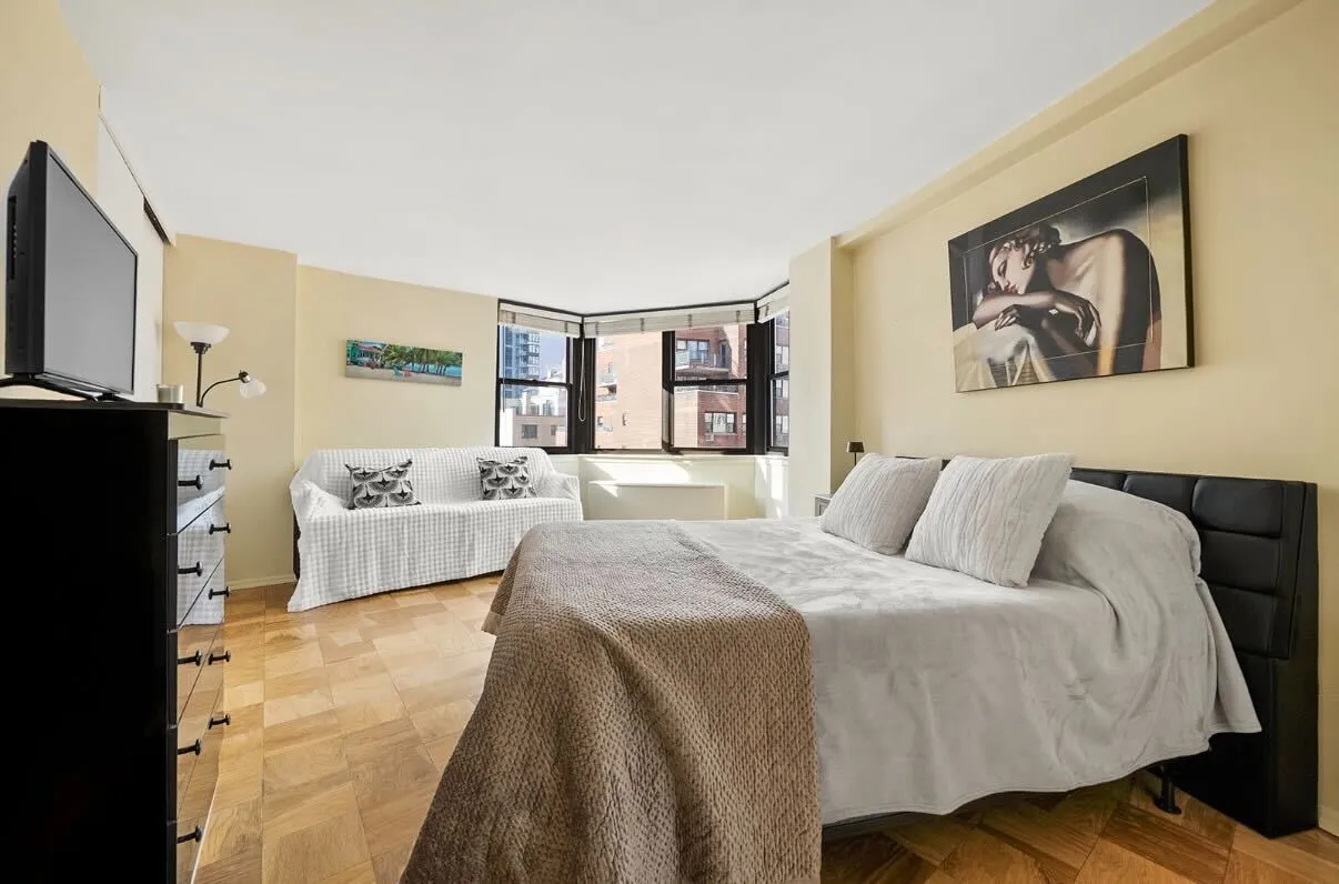 a bedroom with a large bed and a couch