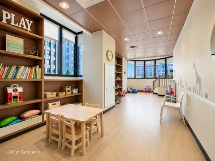 a living room with furniture and a book shelf