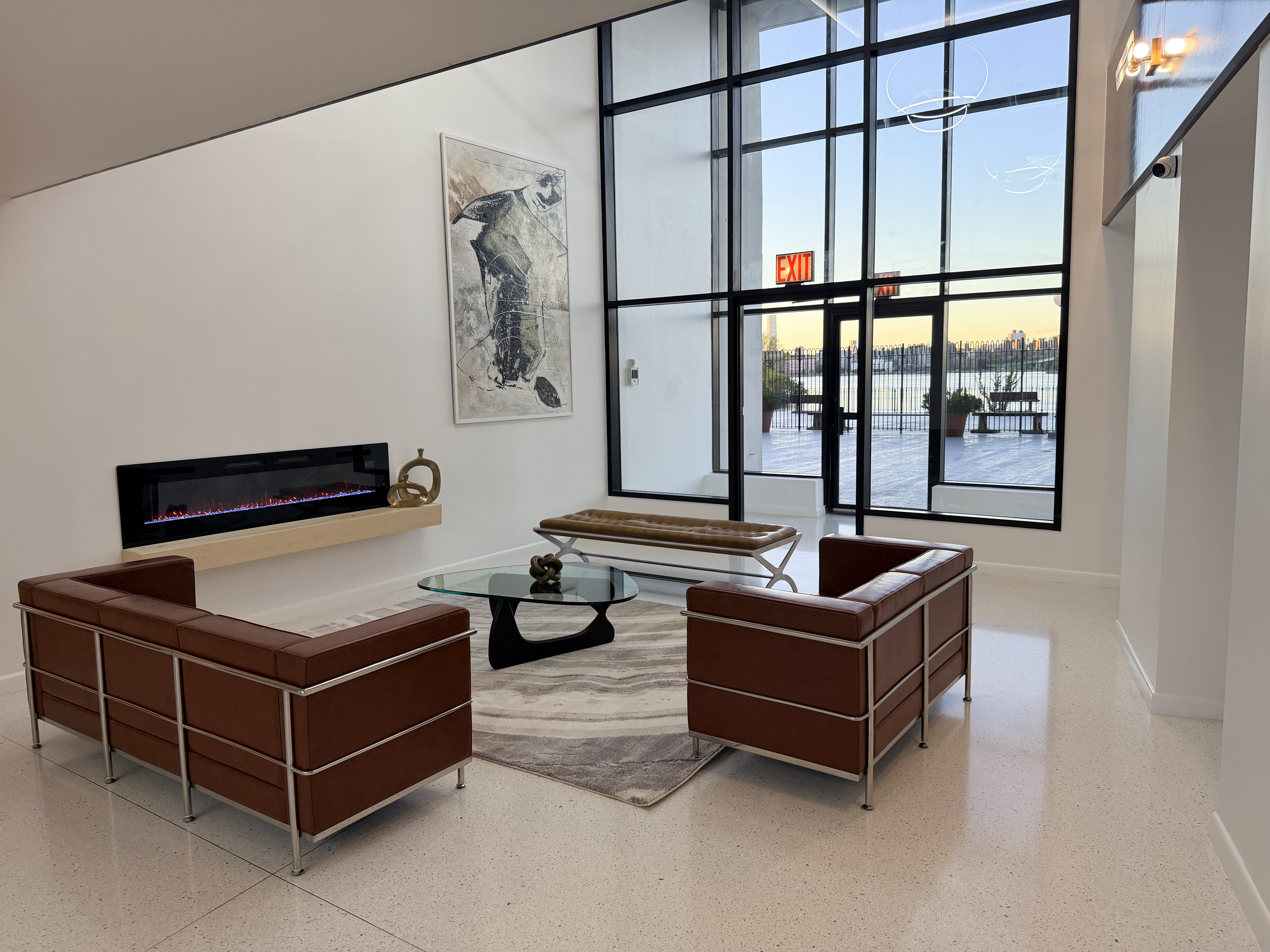 2540 Shore Boulevard, Unit 4S Queens, NY 11102 - Photo 22 of 31 a living room with furniture a window and a glass door