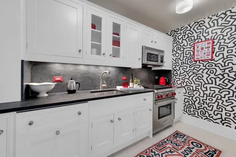 a kitchen with stainless steel appliances granite countertop a sink and cabinets