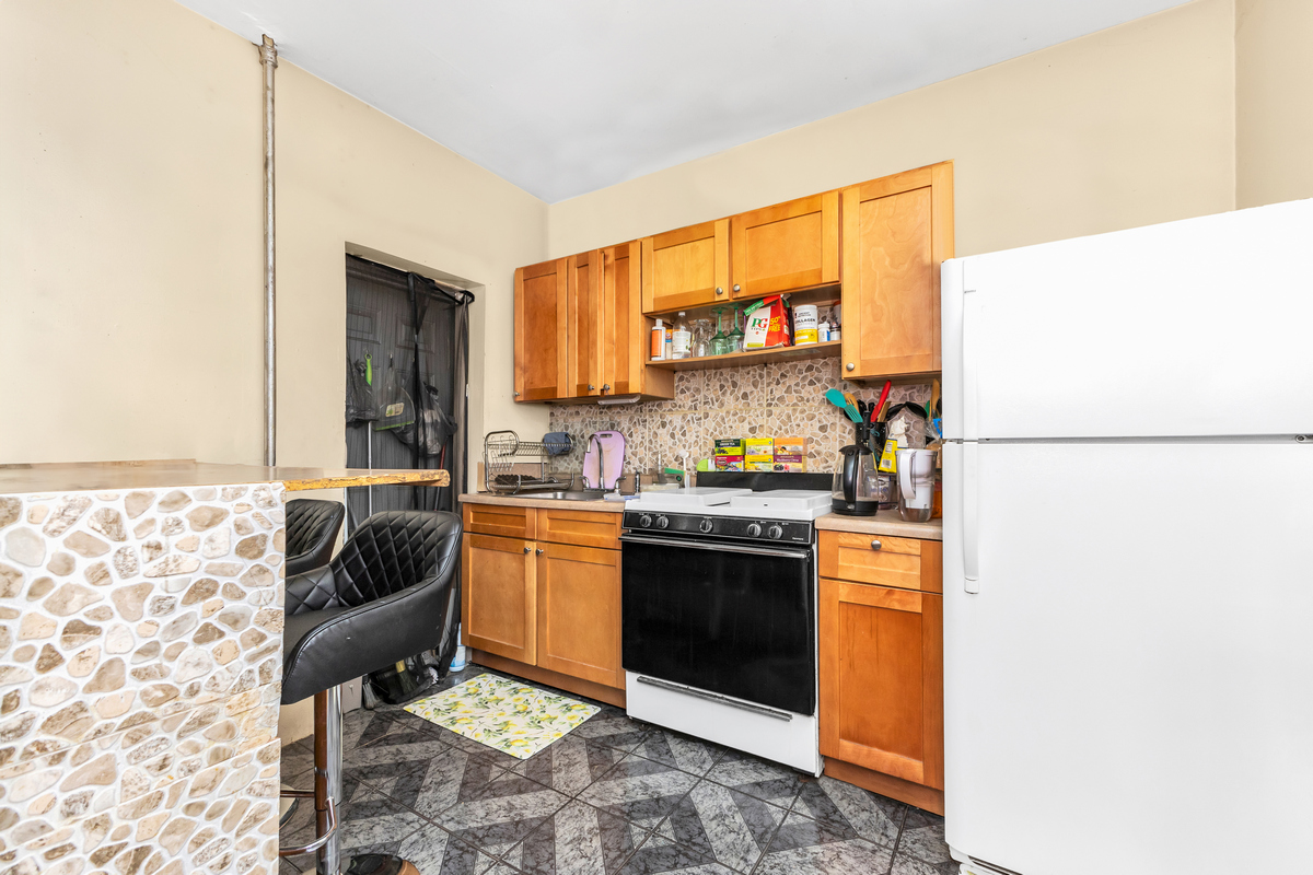 397 Douglass Street Brooklyn, NY 11217 - Photo 10 of 15 a kitchen with stainless steel appliances granite countertop a sink and a refrigerator