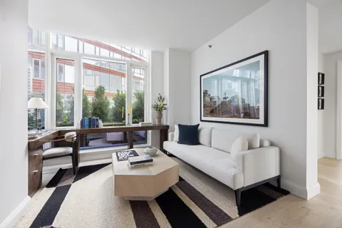 a living room with furniture and a large window with outer view