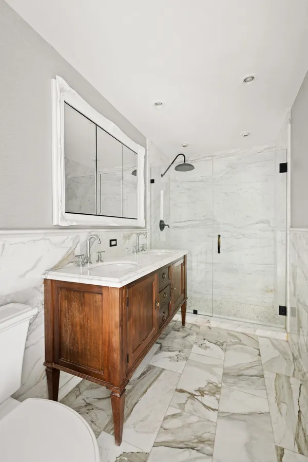 a spacious bathroom with a tub sink and mirror