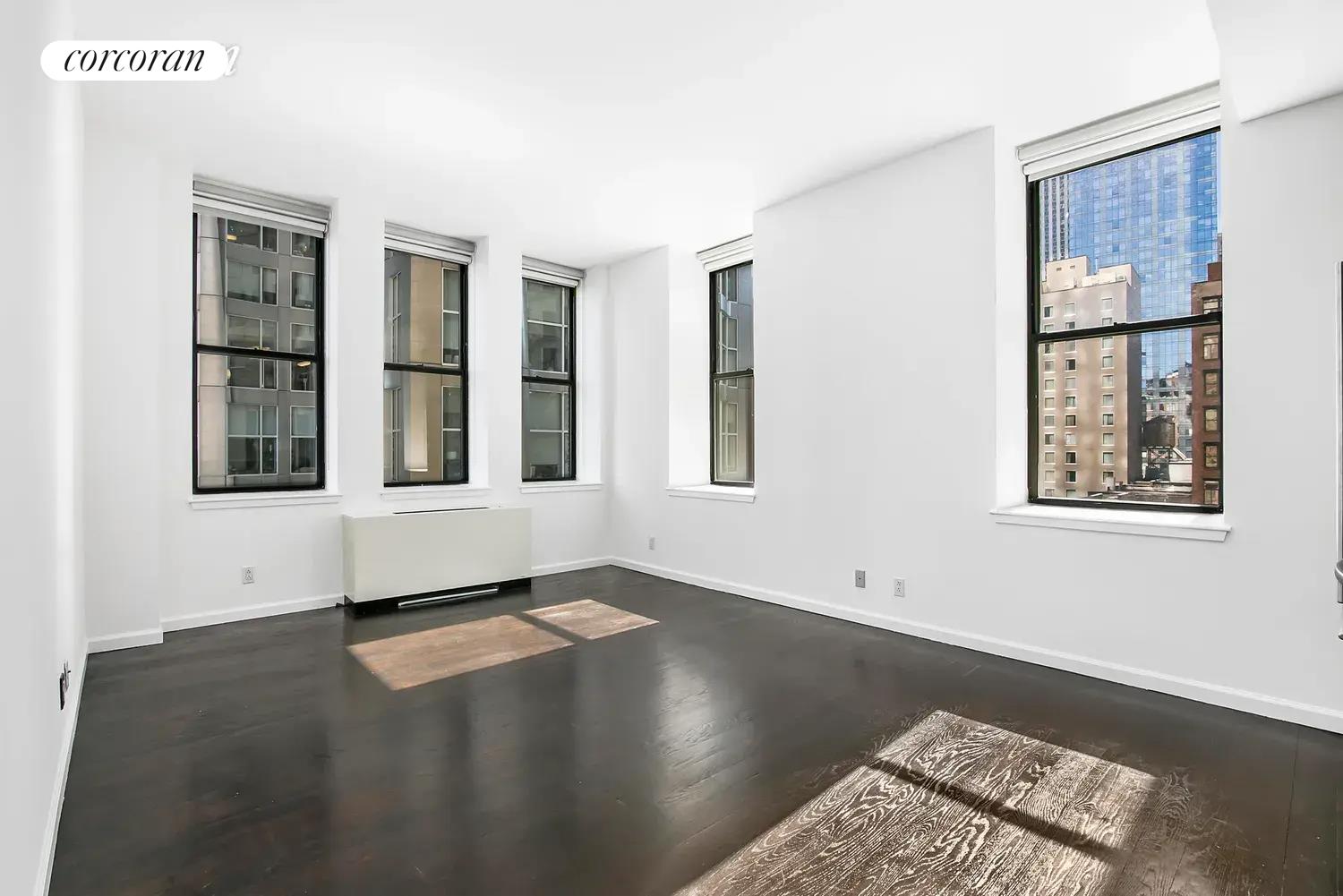150 Nassau Street, Unit 8K Manhattan, NY 10038 - Photo 2 of 8 a view of an empty room with windows