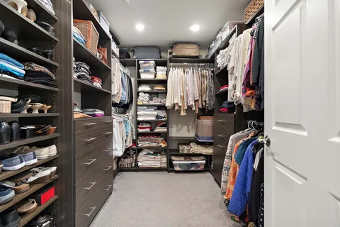 a bedroom with two beds and a chair