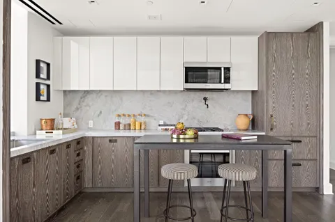 a kitchen with stainless steel appliances a sink a stove a microwave and cabinets