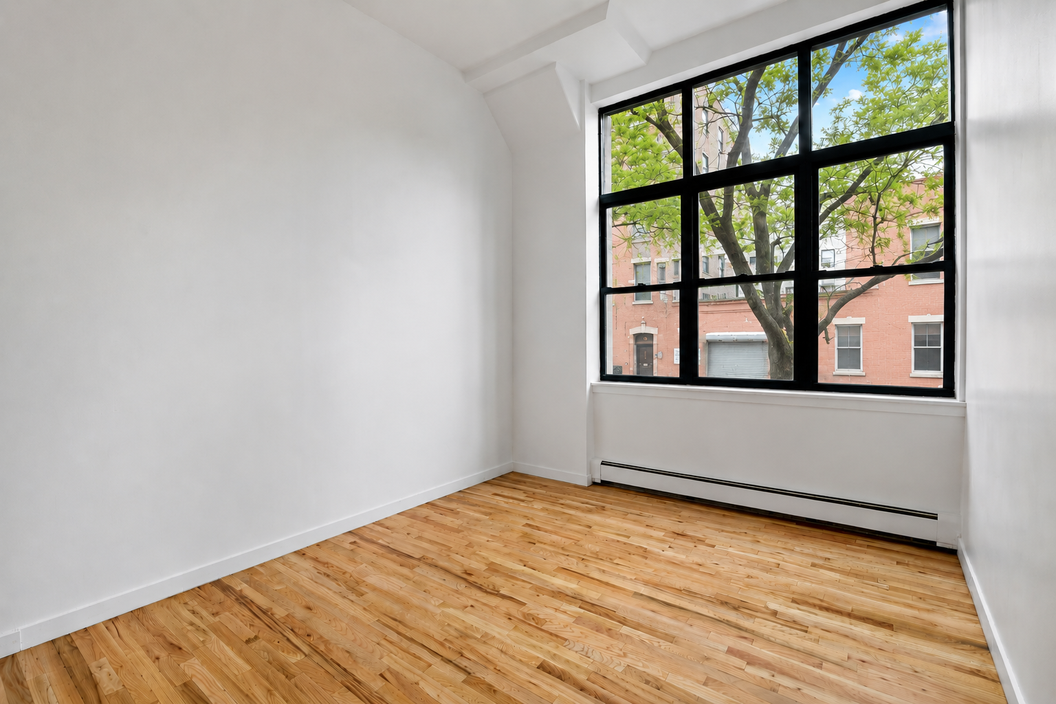 110 Clifton Place, Unit 2B Brooklyn, NY 11238 - Photo 6 of 7 an empty room with wooden floor and windows