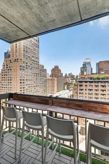 a view of a chairs and table in a balcony