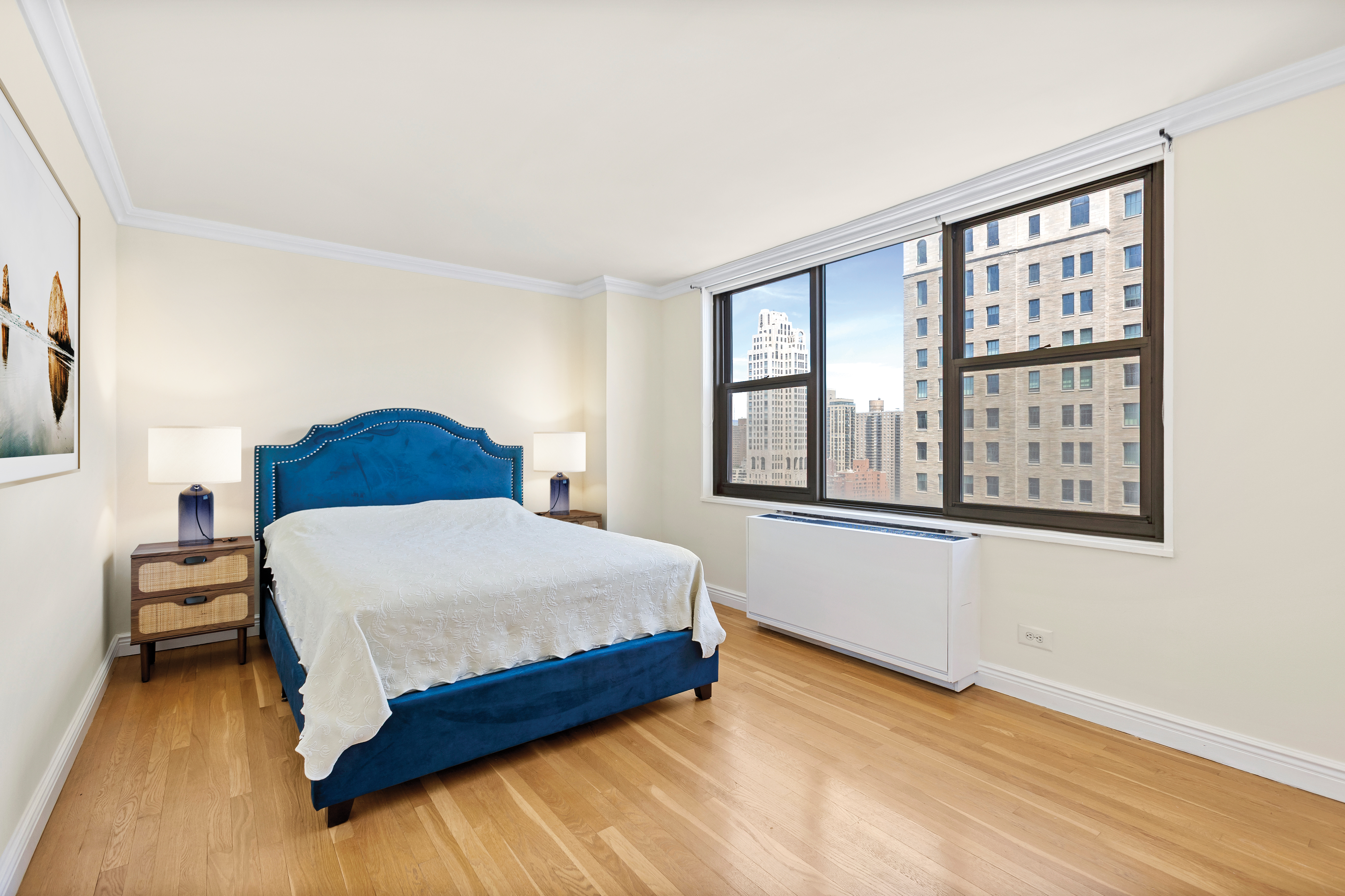 301 East 79th Street, Unit 31F Manhattan, NY 10075 - Photo 3 of 6 a bedroom with a bed and a large window