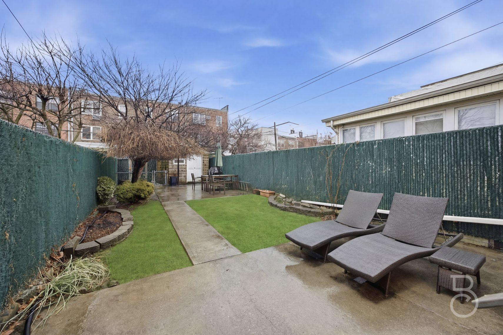 22-61 46th Street Queens, NY 11105 - Photo 15 of 24 a backyard of a house with table and chairs
