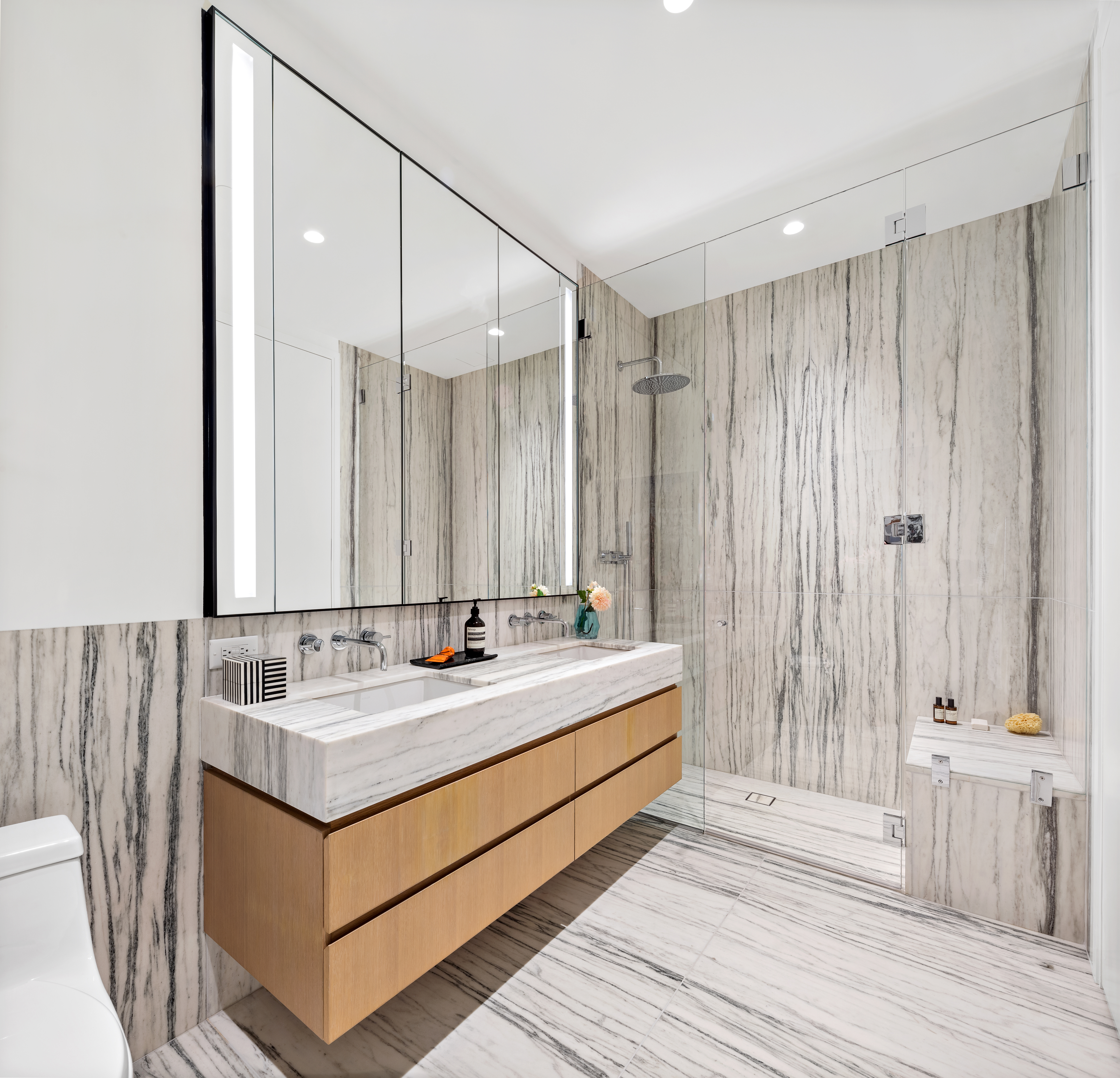 33 Park Row, Unit 10B Manhattan, NY 10038 - Photo 8 of 22 a bathroom with a double vanity sink and a mirror