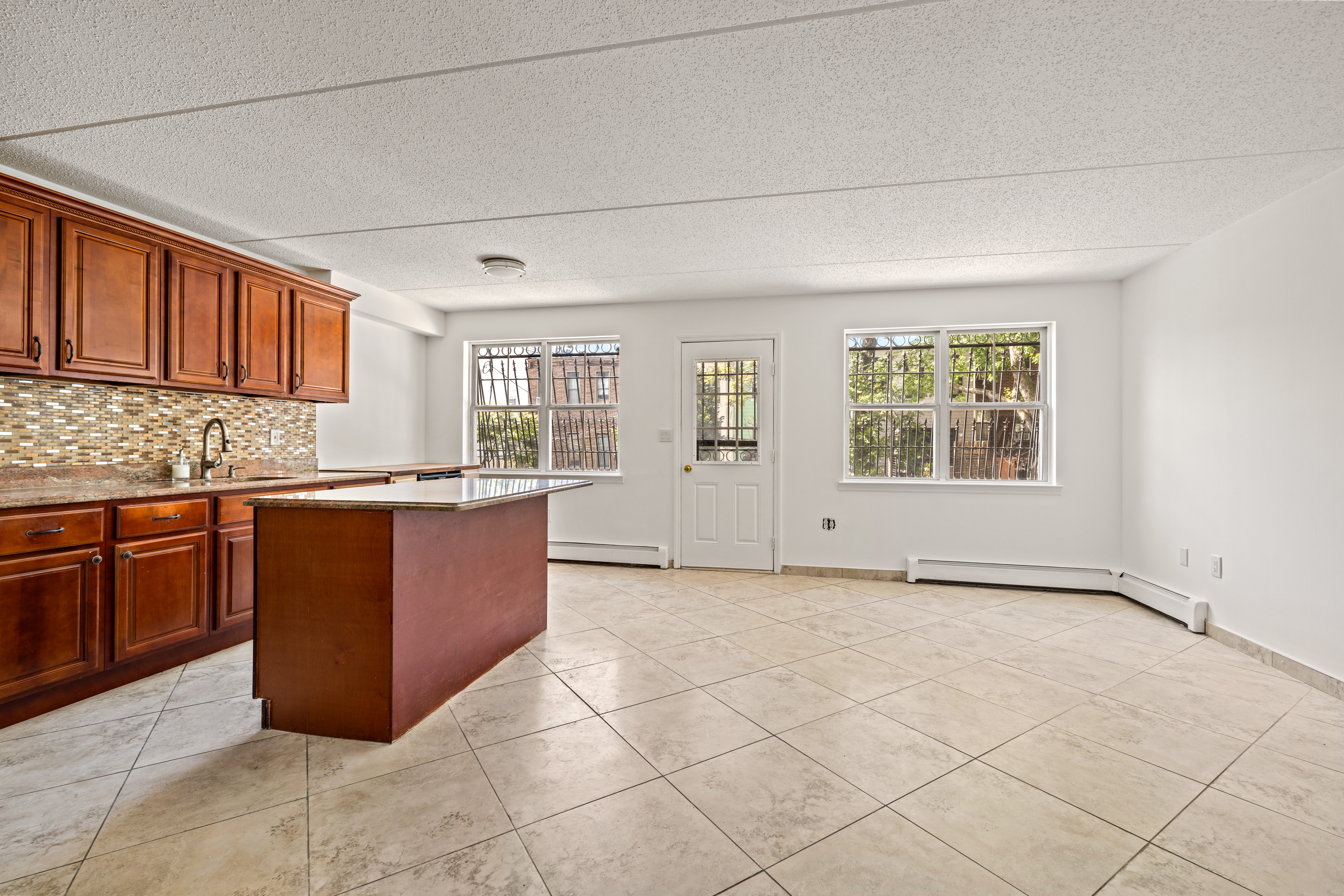 175 Eldert Street, Unit 2 Brooklyn, NY 11207 - Photo 2 of 15 a kitchen with stainless steel appliances granite countertop a stove a sink and a microwave