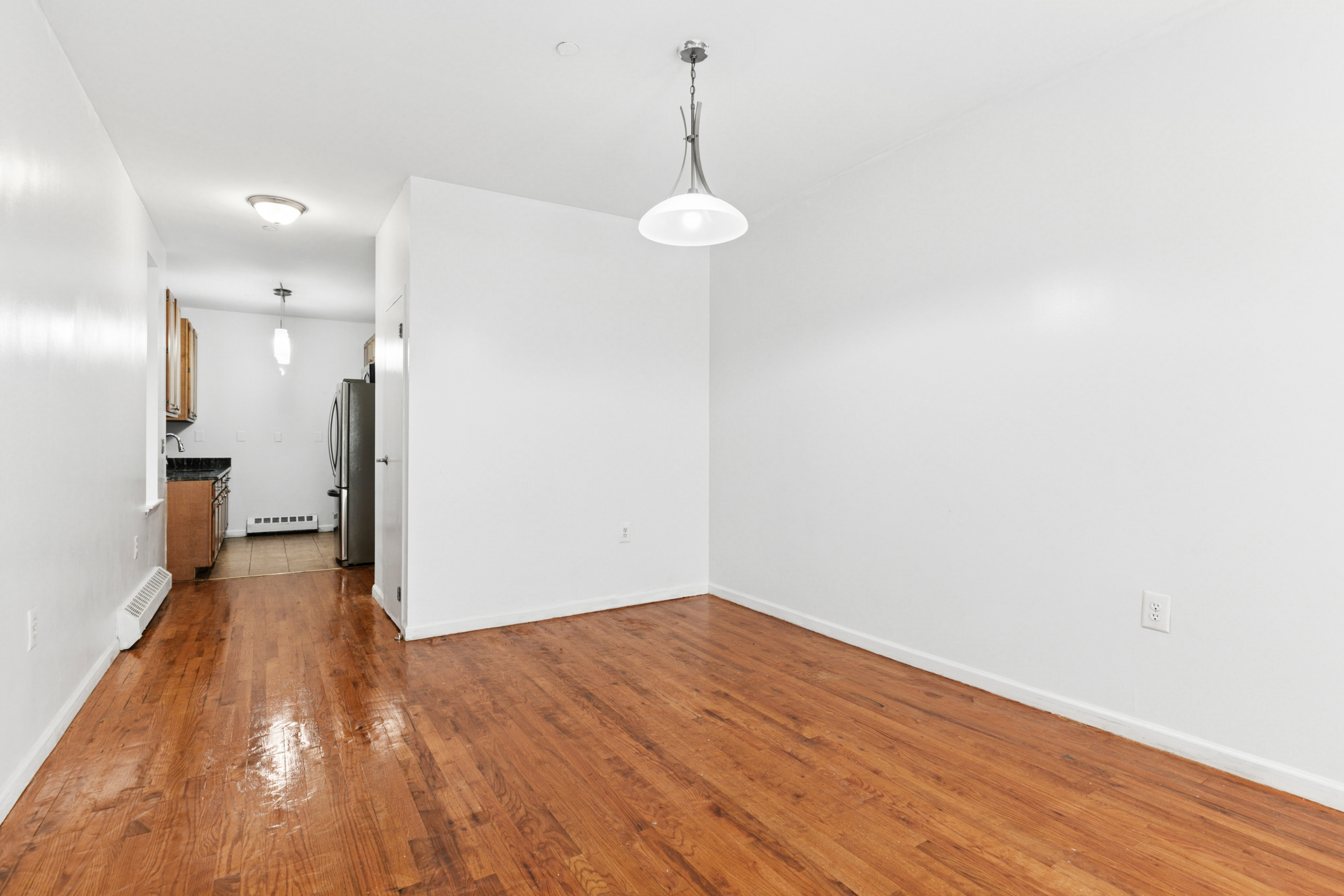 418 West 129th Street, Unit 4 Manhattan, NY 10027 - Photo 4 of 15 a view of a room with wooden floor and a sink