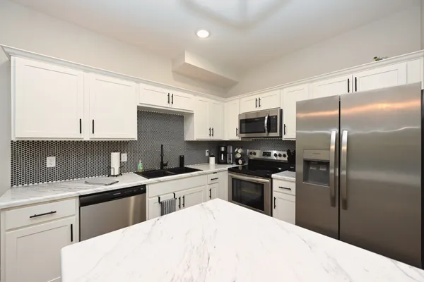 a kitchen with a sink stainless steel appliances and cabinets