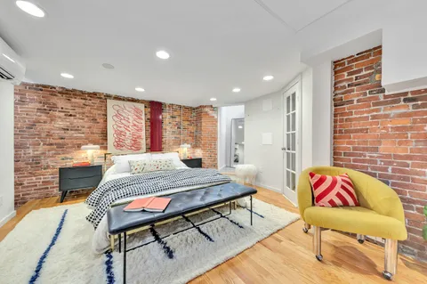 a bedroom with a bed and a chair