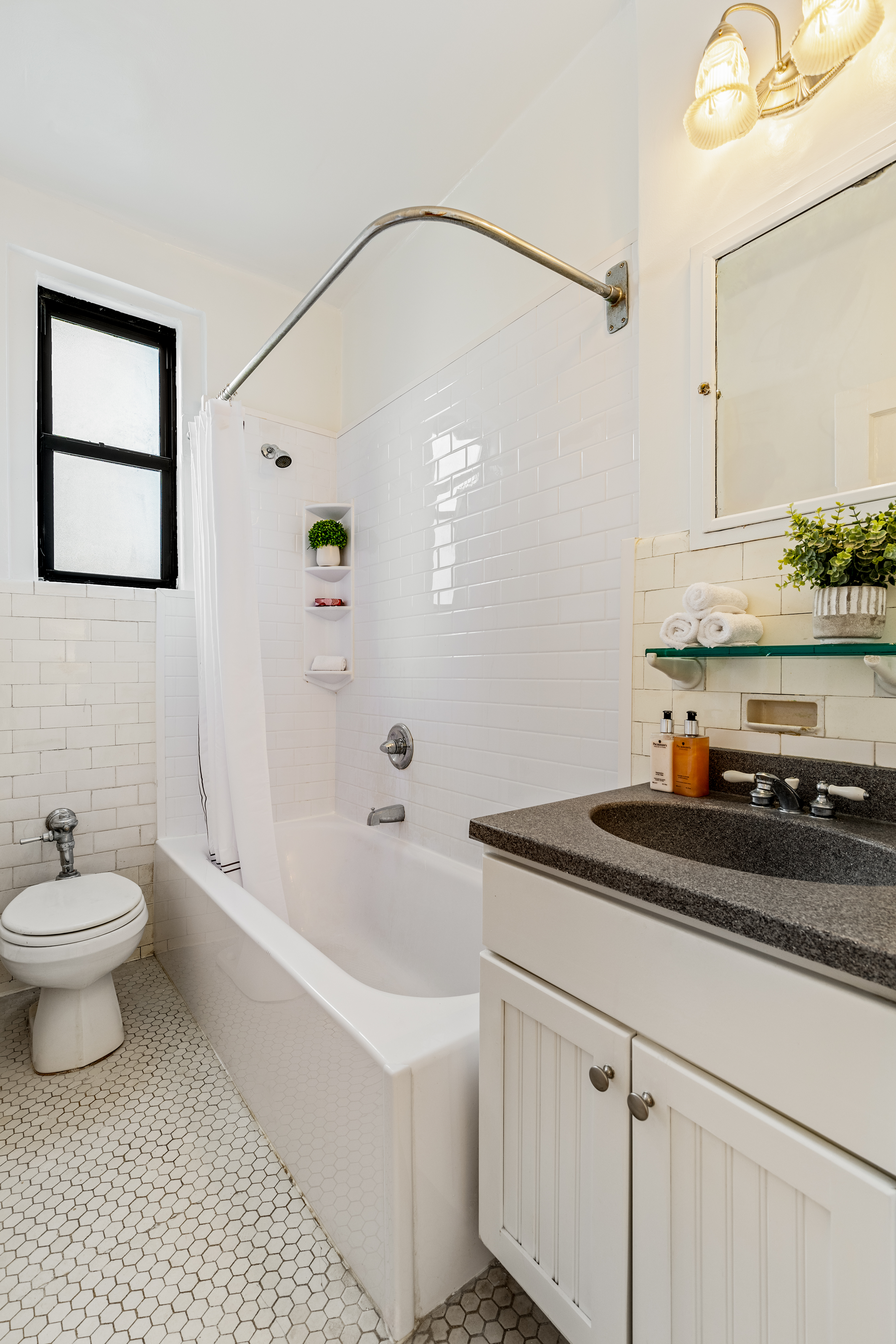 599 West End Avenue, Unit 5A Manhattan, NY 10024 - Photo 6 of 11 a bathroom with a sink a toilet and vanity
