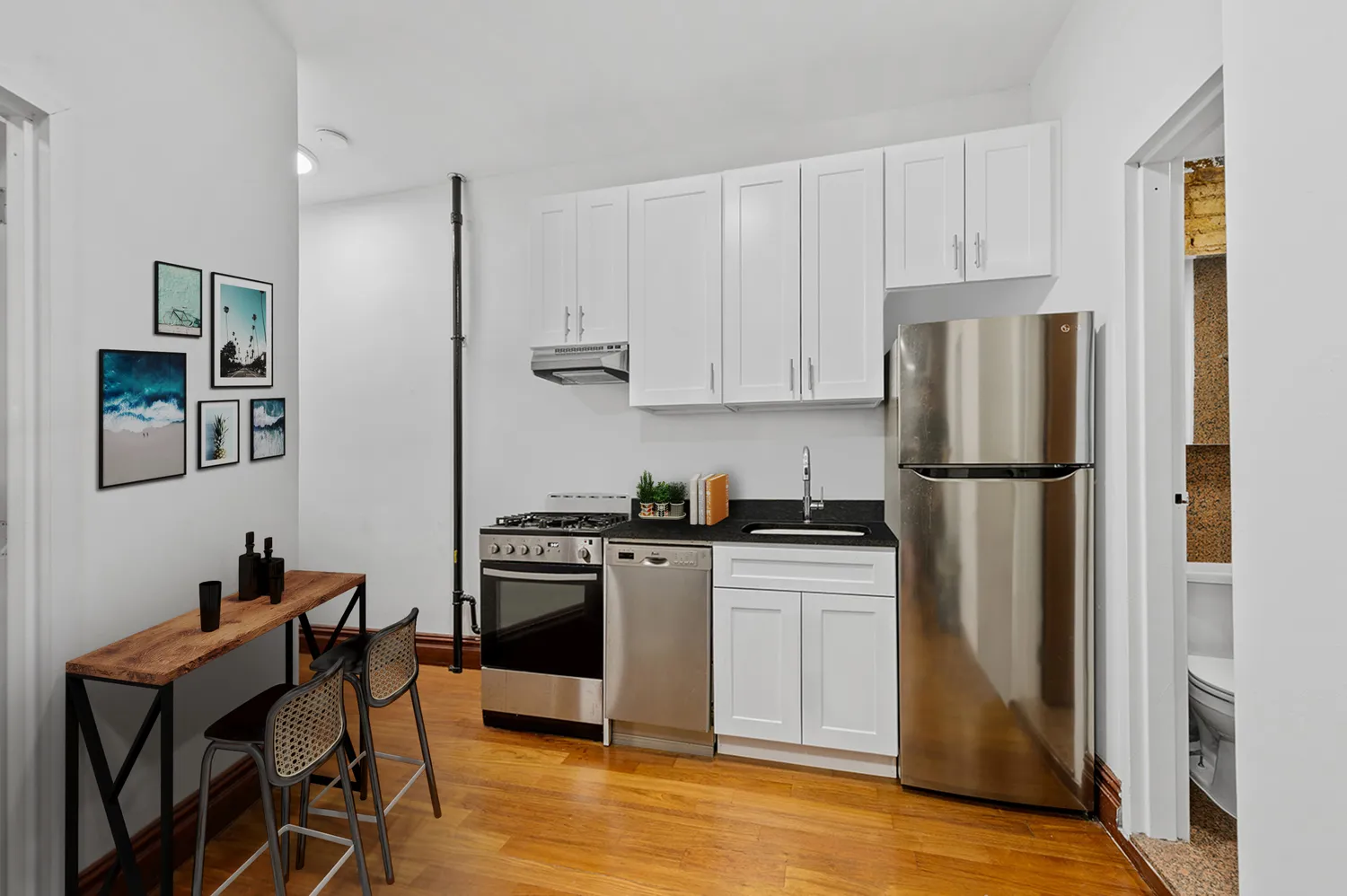 a kitchen with stainless steel appliances granite countertop a refrigerator and a stove top oven