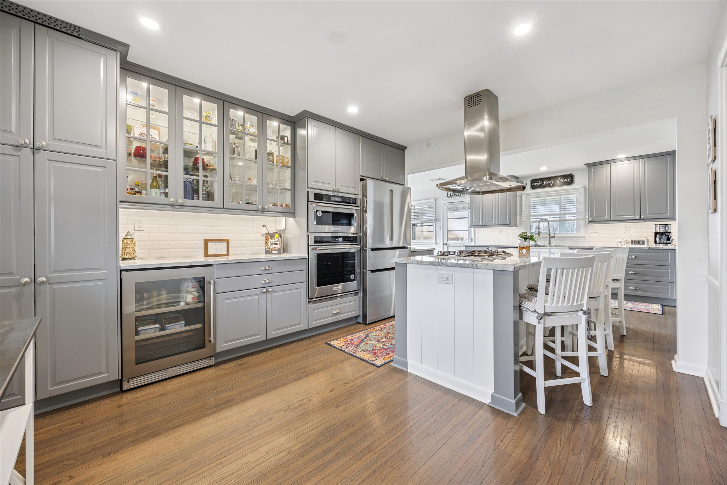 535 Bell Lane Ambler, PA 19002 - Photo 7 of 45 a kitchen with stainless steel appliances a stove a sink dishwasher a refrigerator and white cabinets with wooden floor