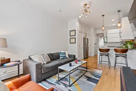 a living room with furniture and a chandelier