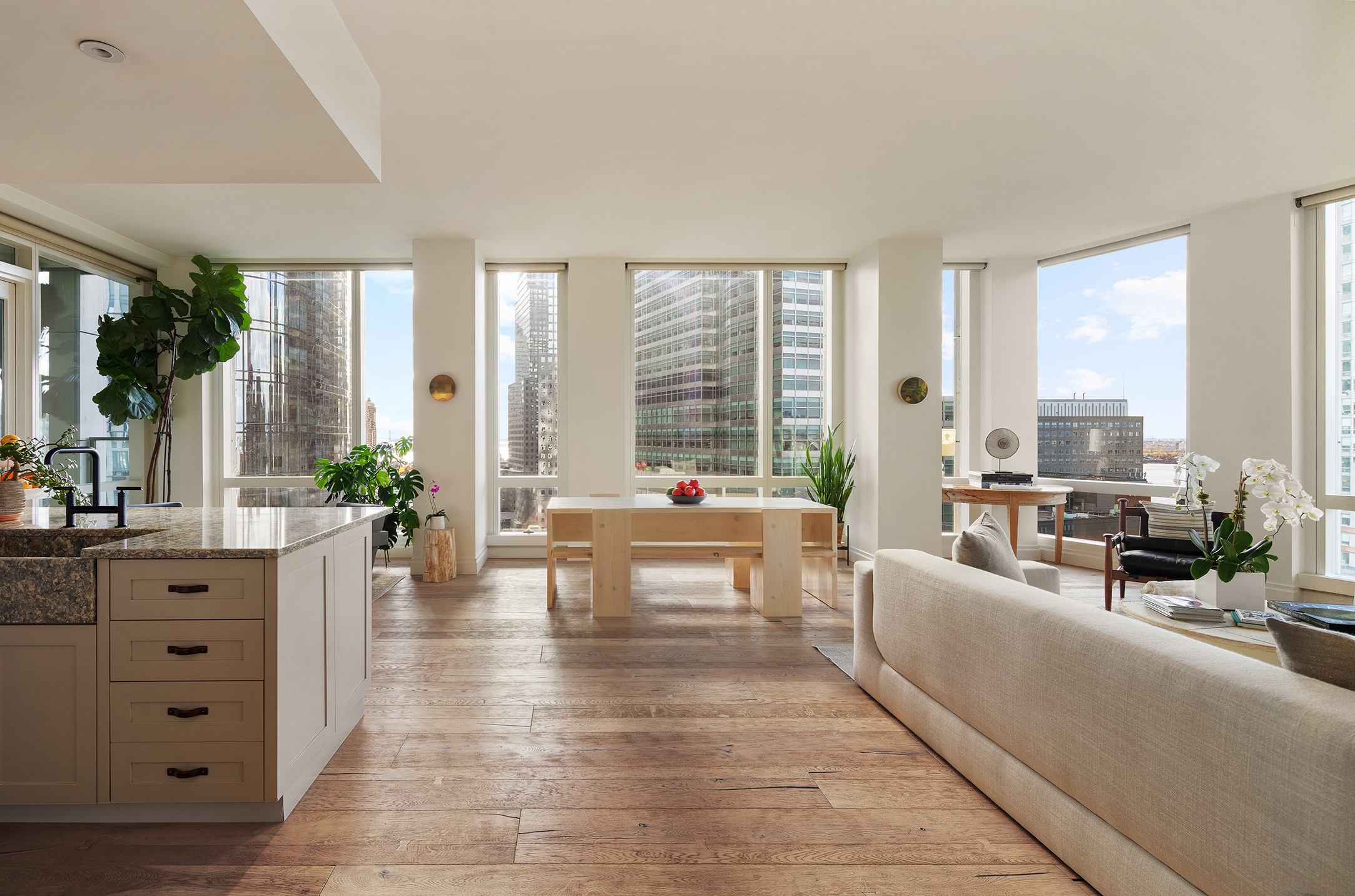101 Warren Street, Unit 2010 Manhattan, NY 10007 - Photo 1 of 18 a living room with furniture large windows and wooden floor