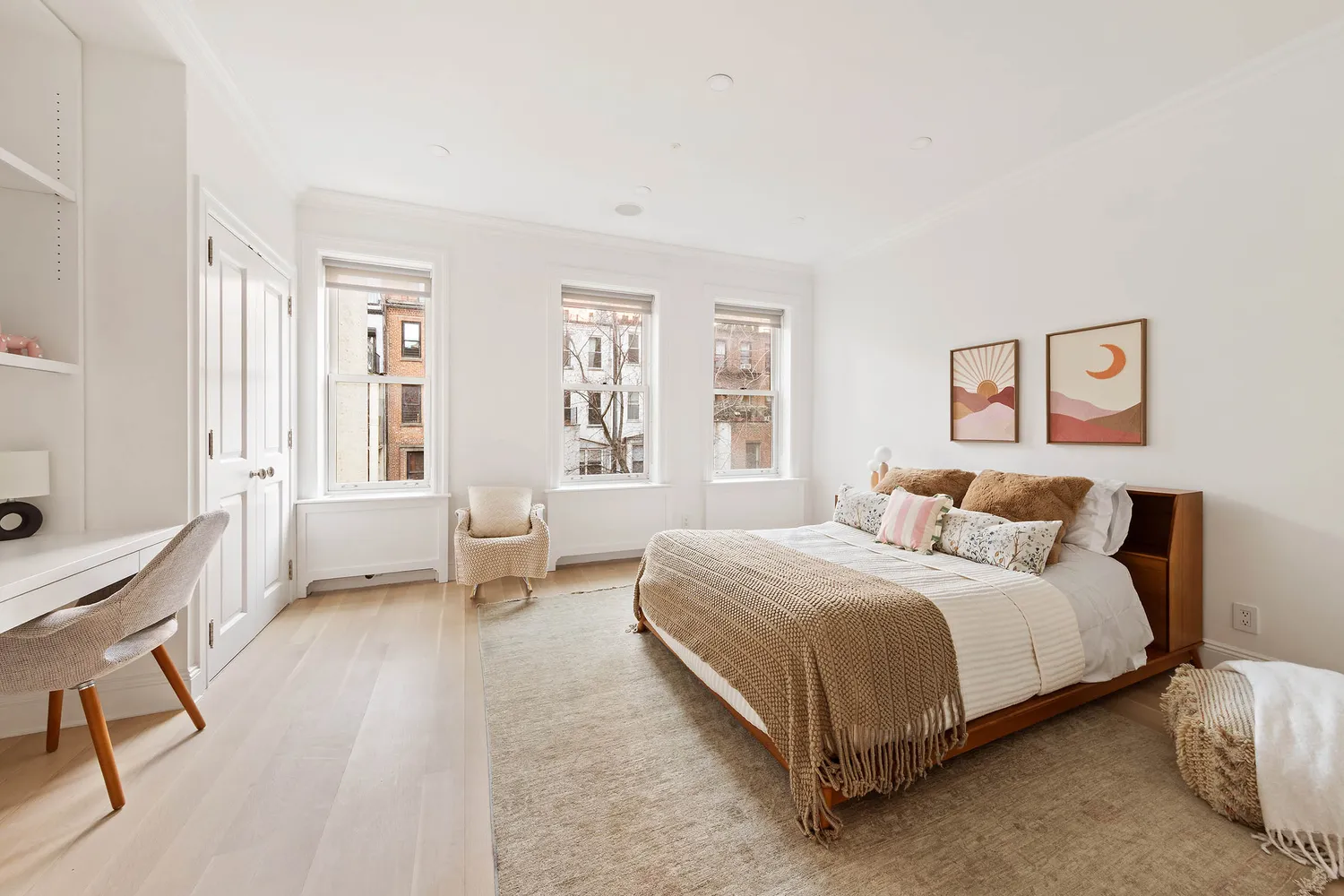 a bedroom with a bed a table and chair