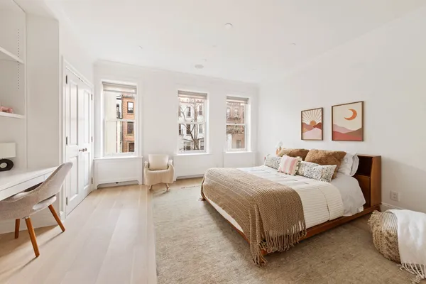 a bedroom with a bed a table and chair